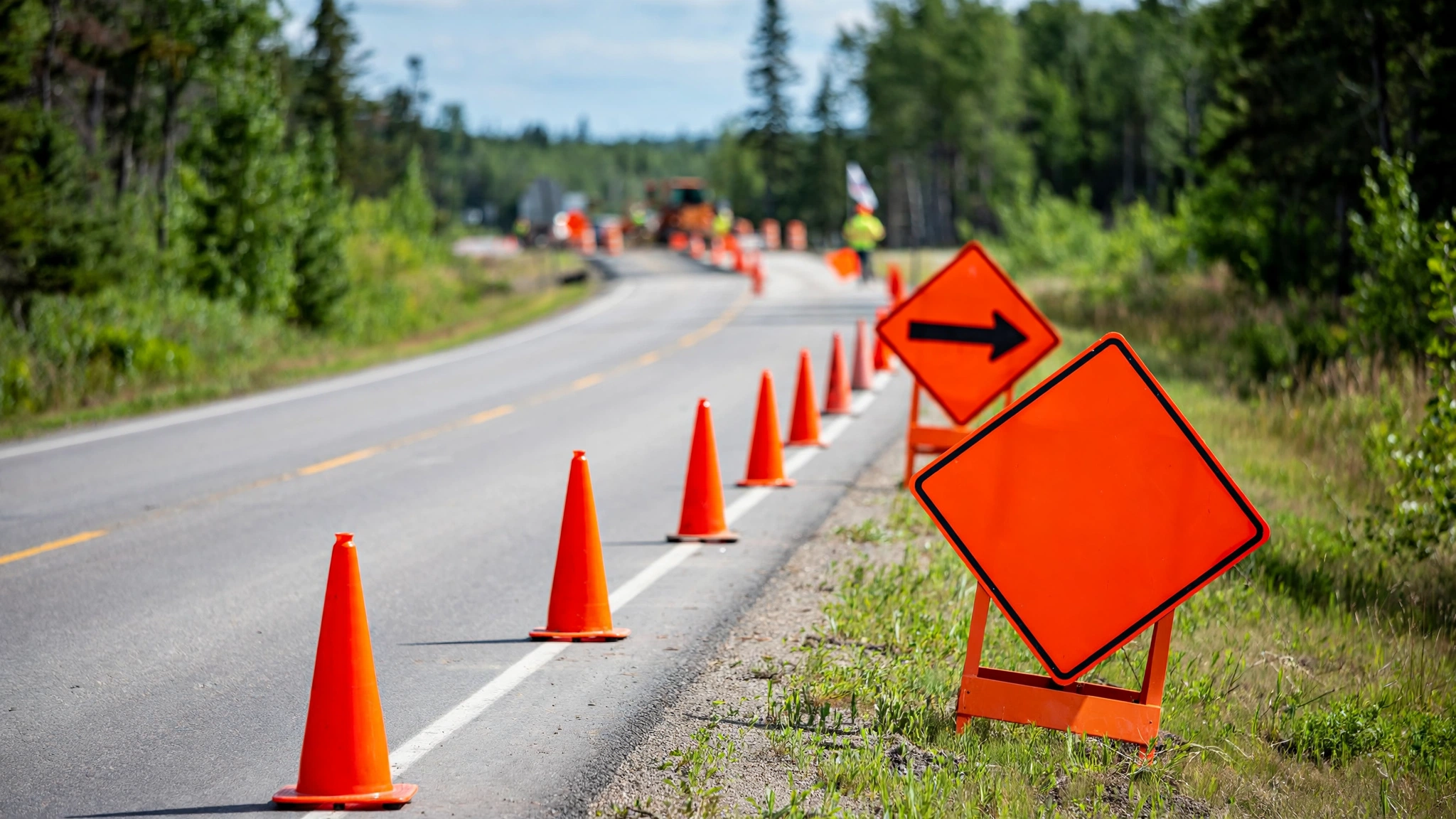 Orange construction signs and traffic cones along an Ontario road work zone